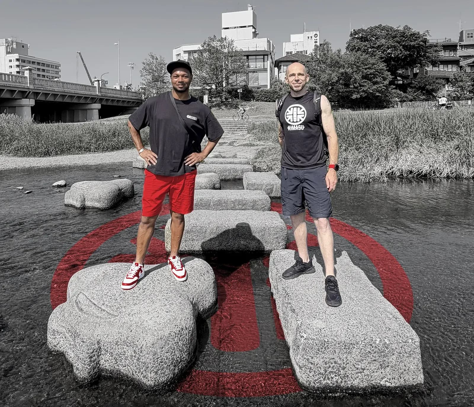 Kimasu guides on the Kamo River stepping stones, Kyoto